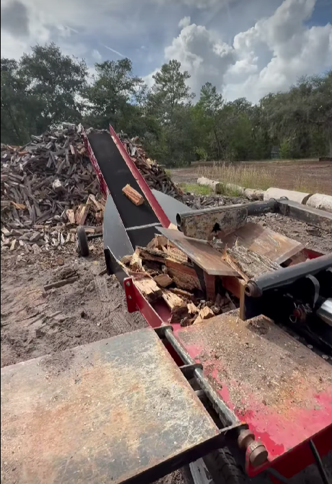 Close-up of seasoned hardwood firewood logs stacked and ready for sale